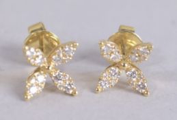 A PAIR OF 18CT GOLD AND DIAMOND FLOWER EARRINGS.