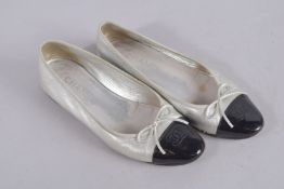 A PAIR OF CHANEL BALLET SHOES, silver with black toes, size 40.5, in Chanel bag. Signs of wear.