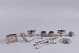 A PAIR OF SILVER SERVIETTE RINGS, pair of miniature trophy cups, matchbox cover, sifter spoon and