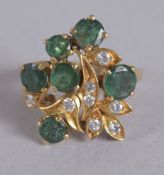 AN 18CT EMERALD AND DIAMOND FLOWER RING.