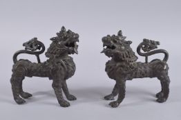 A FINE PAIR OF BRONZE LION DOG FIGURES, 16cm long.
