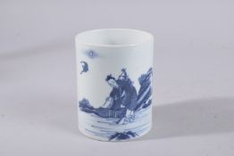 A CHINESE BLUE AND WHITE PORCELAIN BRUSH POT, painted with a figure and bat, 12cm high.