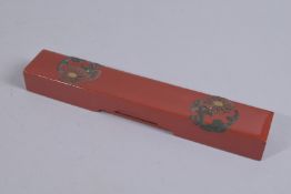 A FINE RED LACQUER PEN BOX CONTAINING SILVER PEN, 24cm long.