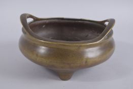 A LARGE CHINESE BRONZE TWIN HANDLE TRIPOD CENSER, the base with character mark, 23cm diameter.