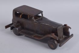 AN ANGLO INDIAN CARVED COROMANDEL WOOD VINTAGE CAR, 32cm long.