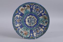 A FINE 19TH CENTURY PERSIAN QAJAR GLAZED POTTERY DISH, 28.5cm diameter.