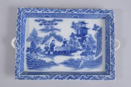 A CHINESE BLUE AND WHITE PORCELAIN RECTANGULAR TRAY, depicting a landscape scene with a boy riding