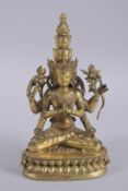 A GILT BRONZE BUDDHISTIC SEATED MULTI-HEAD DEITY, on a lotus base, 28cm high.