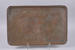 AN EARLY QAJAR ENGRAVED COPPER TRAY, 59cm x 39cm.