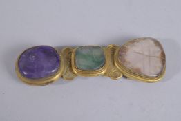 A CHINESE GILT METAL BELT BUCKLE INSET WITH STONES, 9cm long.