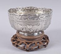 A VERY FINE CHINESE WING FAT EMBOSSED SILVER BOWL ON HARDWOOD STAND, with finely chased relief