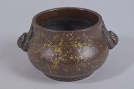 A CHINESE GOLD SPLASH BRONZE TWIN HANDLE CENSER, the base with character mark, 15cm wide handle to