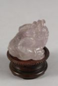 A CHINESE CARVED ROSE QUARTZ TOAD ON HARDWOOD STAND, rose quartz 6.5cm high, 7cm long.