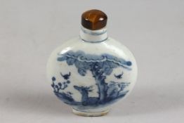 A CHINESE BLUE AND WHITE PORCELAIN SNUFF BOTTLE AND TIGER'S EYE STOPPER, painted with a deer beneath