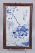 A CHINESE BLUE AND WHITE PORCELAIN PLAQUE IN HARDWOOD FRAME, 62cm x 40cm.