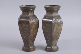 A PAIR OF JAPANESE HEXAGONAL BRONZE VASES, with raised decoration depicting cranes and other birds