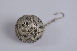 A CHINESE WHITE METAL SPHERICAL INCENSE BURNER.