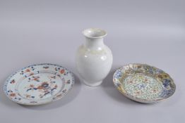 A CHINESE WHITE GLAZE PORCELAIN VASE, faintly carved with blossoming fruit, character mark to