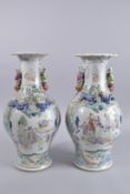 A PAIR OF 19TH CENTURY CHINESE FAMILLE VERTE PORCELAIN TWIN HANDLE VASES, painted with panels of