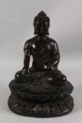 A FINE AND LARGE 17TH-18TH CENTURY BRONZE BUDDHA, seated upon a lotus base with inscription to