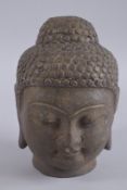 A CARVED STONE BUDDHA HEAD, 24cm high.