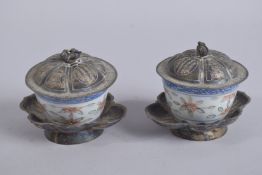 A PAIR OF 20TH CENTURY CHINESE METAL MOUNTED PORCELAIN CUPS AND COVERS, the base with six-