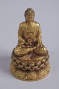A GILT ALLOY SHAKYAMUNI BUDDHA, seated upon a lotus base, 11cm high.