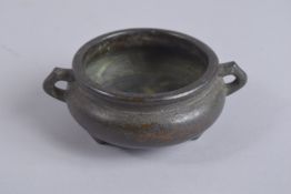 A CHINESE BRONZE TWIN HANDLE CENSER, with character mark to base, 12.5cm wide handle to handle.