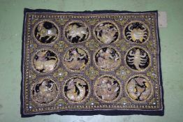 A BURMESE SEQUIN EMBROIDERED AND PADDED ASTROLOGICAL HOROSCOPE TEXTILE PANEL, 88cm x 110cm.