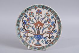 A 19TH CENTURY OTTOMAN TURKISH KUTAHIYA POTTERY DISH, 23cm diameter.