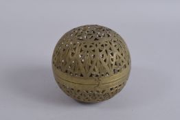A 19TH CENTURY BRASS OPENWORKED HAND WARMER, 12cm high.