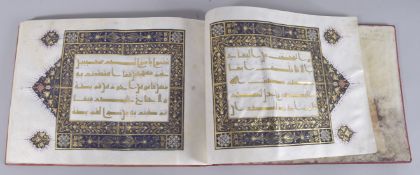 A FINE 20TH CENTURY LEATHER BOUND KUFIC STYLE QURAN, with gilt illuminated vellum pages, 29.5cm x