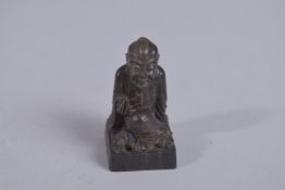 A FINE CHINESE CARVED HORN FIGURAL SEAL, 4.3cm high.