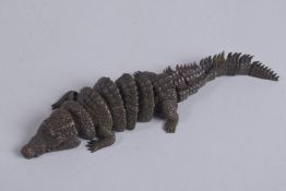 AN ARTICULATED BRONZE OKIMONO OF A CROCODILE, 20cm long.