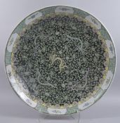 A VERY LARGE CHINESE FAMILLE VERTE PORCELAIN CHARGER, decorated with dragons amongst vines on a