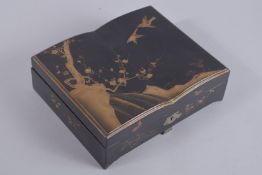 A JAPANESE GILT AND BLACK LACQUER GAMING BOX, containing four compartments of gaming counters, 25.