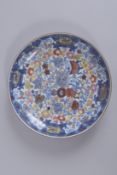 A 19TH CENTURY CHINESE CLOBBERED BLUE AND WHITE PORCELAIN DISH, 25cm diameter.
