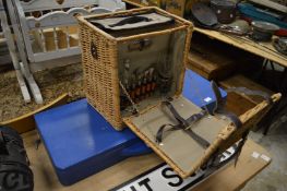 Wicker picnic hamper and a folding picnic table.
