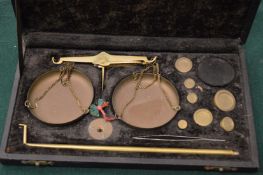 A cased set of scales and weights.