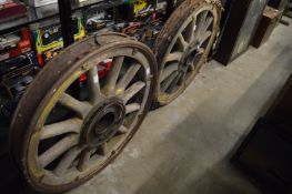 Two old wooden and iron wheels.