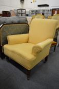 A Victorian armchair with pale yellow upholstery.