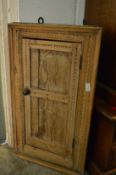 A rustic pine hanging corner cabinet.