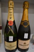A bottle of Moet and Chandon Champagne and a bottle of Drappier Champagne.