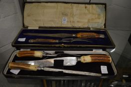 Two sets of antler handled carving knives and forks (one lacking sharpener).