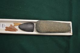A hand axe, three arrow tips and another item.