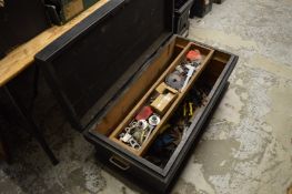 An old carpenters chest containing numerous tools.