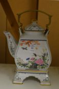 An Oriental teapot on stand.