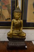 A fine 18th century Burmese gilded carved wood Buddha, seated upon a lotus base, together with a