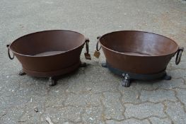 A pair of wrought iron oval twin handled planters.