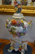 Continental floral encrusted porcelain urn and cover.